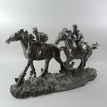 A silver painted model of two race horses,