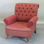 A red upholstered button back armchair,