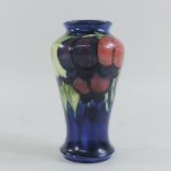 A Moorcroft pottery vase, in the plum pattern, impressed marks and painted monogram to base,