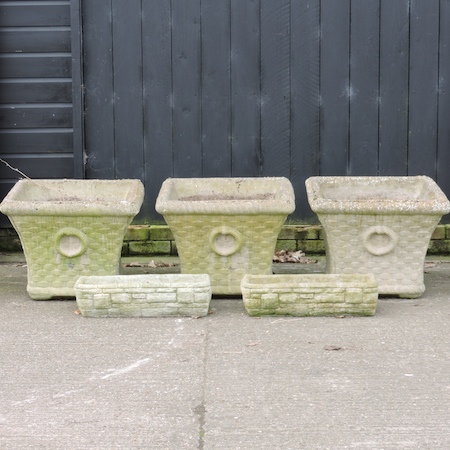 Three large stone garden planters, each 50 cm tall,