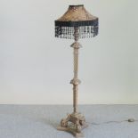 A large ornate gilt lamp and shade,