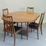 A 1970's G-Plan teak extending dining table, with an additional leaf,