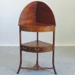 A George III mahogany and boxwood strung corner washstand,