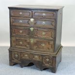 A Charles II oak chest, containing two short over three long graduated geometric moulded drawers,