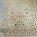 A Chinese woollen carpet, with floral designs on a cream ground,