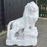 A carved white marble model of a lion, shown standing,