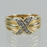 A 14 carat gold and diamond crossover ring,