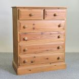 A modern pine chest of drawers,