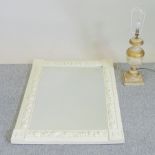 A carved and cream painted wall mirror, 102 x 75cm,