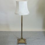 A brass standard lamp, in the form of a corinthian column, with shade,