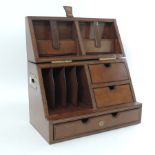 A brown leather stationery box, with a fitted interior,