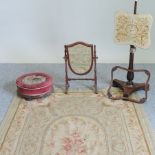 A Victorian footstool, together with a mahogany shield shaped toiletry mirror,