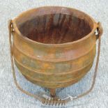 A rusted iron cauldron,