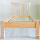 A beech single bedstead, with a slatted wooden base,