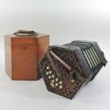 An early 20th century concertina, bearing a label for J B Copplestone, 87382, with bone keys,