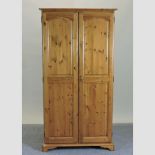 A modern pine double wardrobe,