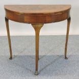 A 1930's walnut folding card table,