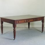 A Regency style partner's writing desk, with an inset leather top, on fluted legs,