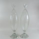 A pair of tall cut glass jars and covers, with hobnail decoration,