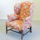 A 19th century floral upholstered wing armchair