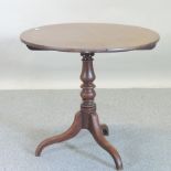 A 19th century oak occasional table, with a circular tilt-top, on a tripod base,