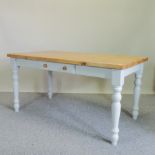 A painted pine table, containing a single drawer,