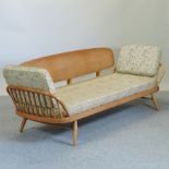A 1970's Ercol medium elm spindle back day bed, with loose cushions,