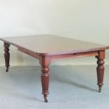 A Victorian mahogany wind-out extending dining table, with two additional leaves, on fluted legs,