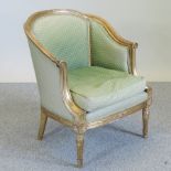 A green upholstered and carved gilt framed fauteuil