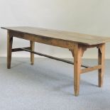 An 18th century refectory table, with a plank top, on tapered legs,