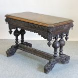 A 19th century heavily carved dark oak centre table, on dolphin feet,