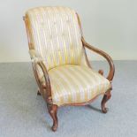 A Victorian mahogany and striped upholstered open armchair,