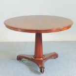 A Victorian mahogany circular breakfast table, on a platform base,