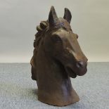 A rusted iron bust of a horse head,