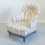 A Victorian striped upholstered button back armchair, the leg stamped G.A.S.