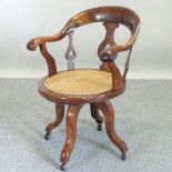 An early 20th century revolving desk chair,