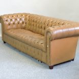 A tan upholstered button back Chesterfield sofa,