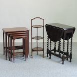 A nest of four occasional tables, together with a cake stand and an oak gateleg table,