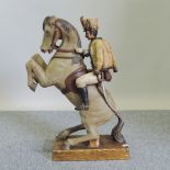 A painted figure group of a soldier on horseback,