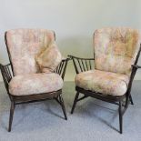 A pair of Ercol dark elm open armchairs