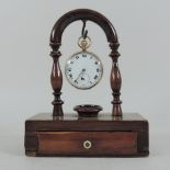 A 9 carat gold cased pocket watch, with a white enamel dial, on a Victorian mahogany watch stand,