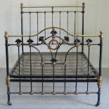 A Victorian brass and iron double bedstead, with a sprung base,