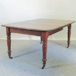 A Victorian mahogany pull-out extending dining table, with an additional leaf, on turned legs,