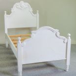 A white painted single bed,