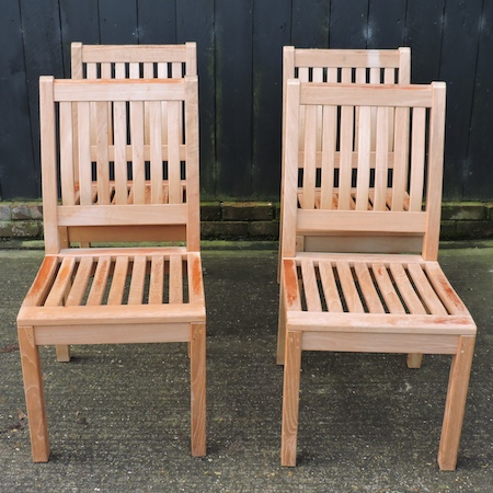 A set of four teak garden chairs,