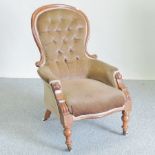 A Victorian carved walnut and brown upholstered button back armchair