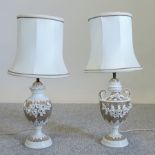 A near pair of continental porcelain gilt painted table lamps and shades,