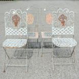 A pair of green painted metal garden chairs,