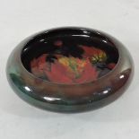 A Moorcroft flambe pottery dish, in the leaf and berries design,