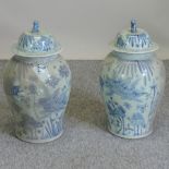 A pair of Chinese blue and white pottery ginger jars and covers,